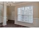 Bright dining area showcasing a large window, stylish wainscoting, and hardwood floors at 1623 Bradmere Ln, Lithia Springs, GA 30122