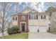 Charming two-story home featuring a brick facade, two-car garage, and well-maintained landscaping at 1623 Bradmere Ln, Lithia Springs, GA 30122