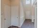 Traditional style hallway that includes dark hardwood floors, paneled walls, and white doors at 1623 Bradmere Ln, Lithia Springs, GA 30122