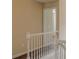 Upstairs hallway with wood floors and white railings and trim at 1623 Bradmere Ln, Lithia Springs, GA 30122