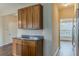 Kitchen cabinet detail with dark countertops and views into the naturally lit sunroom at 1623 Bradmere Ln, Lithia Springs, GA 30122