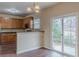 Eat-in kitchen featuring hardwood floors, ample wooden cabinetry, and sliding doors to the backyard at 1623 Bradmere Ln, Lithia Springs, GA 30122