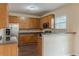 Cozy kitchen with wooden cabinets, granite countertops, and stainless steel refrigerator at 1623 Bradmere Ln, Lithia Springs, GA 30122