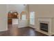 Bright living room with wood floors, fireplace, and arched entryways leading to the kitchen at 1623 Bradmere Ln, Lithia Springs, GA 30122