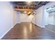 Basement living area with new flooring and exposed ceiling at 1417 Iris Lake Rd, Mcdonough, GA 30252