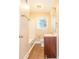 A bathroom featuring a window, wooden vanity and shower-tub combo at 1417 Iris Lake Rd, Mcdonough, GA 30252