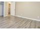Bright bedroom features light gray walls and durable gray wood-look vinyl flooring at 1417 Iris Lake Rd, Mcdonough, GA 30252