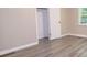 Bright bedroom features light gray walls and durable gray wood-look vinyl flooring at 1417 Iris Lake Rd, Mcdonough, GA 30252