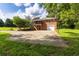 Rear exterior view of a two-story brick home with an attached garage and a spacious driveway at 1417 Iris Lake Rd, Mcdonough, GA 30252