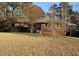 Charming single-story home featuring a brick facade and mature trees in a large, open front yard at 1417 Iris Lake Rd, Mcdonough, GA 30252