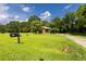 Charming single story home with a lush green front yard and mature trees on a sunny day at 1417 Iris Lake Rd, Mcdonough, GA 30252