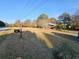Inviting view of home with trees and a well-manicured lawn leading up to the house at 1417 Iris Lake Rd, Mcdonough, GA 30252