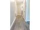 Hallway featuring modern light gray vinyl floors and doors leading to other rooms at 1417 Iris Lake Rd, Mcdonough, GA 30252