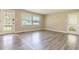 Bright living room with new floors, large windows, and an entry/exit door at 1417 Iris Lake Rd, Mcdonough, GA 30252