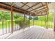 Covered front porch with iron railing provides scenic views of landscaped yard at 1417 Iris Lake Rd, Mcdonough, GA 30252