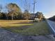 Picturesque property featuring a green lawn, mature trees, and a tranquil setting near the road at 1417 Iris Lake Rd, Mcdonough, GA 30252