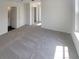 Bright, carpeted bedroom featuring neutral walls, an ensuite bathroom, and a spacious closet at 201 Gallant Se Ln # 25, Mableton, GA 30126