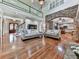 Open-concept living area features hardwood floors, a stone arch, and an open view of the kitchen at 1012 Jubilee Way, Powder Springs, GA 30127