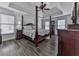 This primary bedroom features a tray ceiling, a ceiling fan, and is illuminated with natural light at 1012 Jubilee Way, Powder Springs, GA 30127