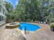 Beautiful in-ground pool with a stone-accented spa and spacious patio for outdoor relaxation and entertaining at 1012 Jubilee Way, Powder Springs, GA 30127