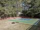 Outdoor basketball court nestled in the woods at 980 Grove Park Ln, Cumming, GA 30041