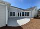 Spacious backyard featuring a concrete patio with easy access to the home through large windows and glass doors at 3577 Fishpond Cir, Dacula, GA 30019