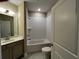 Clean bathroom showcasing a vanity, toilet, and tiled shower-tub combination at 3577 Fishpond Cir, Dacula, GA 30019