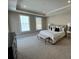 Spacious bedroom with tray ceiling, neutral decor, and plush carpeting at 3577 Fishpond Cir, Dacula, GA 30019