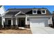 Newly constructed home with gray siding, white trim, and a two-car garage at 3577 Fishpond Cir, Dacula, GA 30019
