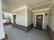 Covered front porch with a stylish entry door and attractive brick accents at 3577 Fishpond Cir, Dacula, GA 30019