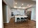 Modern kitchen with stainless steel appliances, a large island, breakfast bar, and ample cabinet space at 3577 Fishpond Cir, Dacula, GA 30019