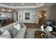 Open-concept living room with built-in shelving, hardwood floors, neutral decor, and comfortable seating at 3577 Fishpond Cir, Dacula, GA 30019
