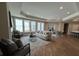 Bright living room featuring large windows, hardwood floors, a fireplace, and modern furniture at 3577 Fishpond Cir, Dacula, GA 30019