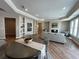 Open-concept living room with built-in shelving, hardwood floors, fireplace, neutral decor, and comfortable seating at 3577 Fishpond Cir, Dacula, GA 30019