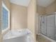 Primary bathroom featuring separate soaking tub and glass door shower at 424 Eglington Trl, Locust Grove, GA 30248