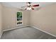 Bedroom featuring neutral tones, carpet flooring, a ceiling fan, and plenty of natural light at 424 Eglington Trl, Locust Grove, GA 30248