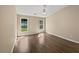 Spacious bedroom features modern wood floors, two windows, and neutral walls at 424 Eglington Trl, Locust Grove, GA 30248