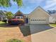 Charming single-story home with a well-manicured lawn and an attached two-car garage at 424 Eglington Trl, Locust Grove, GA 30248
