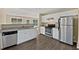 Open kitchen with white cabinetry, stainless steel appliances and granite countertops at 424 Eglington Trl, Locust Grove, GA 30248