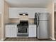 Well-equipped kitchen featuring stainless steel appliances, granite counters, and white cabinetry at 424 Eglington Trl, Locust Grove, GA 30248