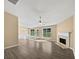 Open living room with hardwood floors, fireplace, ceiling fan, and lots of natural light at 424 Eglington Trl, Locust Grove, GA 30248
