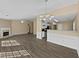 Open concept living room with fireplace flows into the kitchen with modern finishes at 424 Eglington Trl, Locust Grove, GA 30248