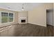 Spacious living room with hardwood flooring, fireplace, ceiling fan, and lots of natural light at 424 Eglington Trl, Locust Grove, GA 30248