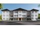Modern apartment building with white exterior and black accents at 1000 Blair Ln # 1, Peachtree City, GA 30269