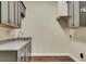 Laundry room with gray cabinets, quartz countertop, and tile flooring at 10700 Stroup Rd, Roswell, GA 30075