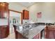 Modern wet bar with granite countertop and wine storage at 10700 Stroup Rd, Roswell, GA 30075