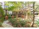 Picturesque courtyard with a pergola-covered seating area, offering a tranquil retreat amidst lush greenery and manicured gardens at 1850 Cotillion Dr # 3123, Dunwoody, GA 30338