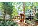 Charming courtyard featuring a pergola-covered walkway surrounded by well-maintained landscaping and mature trees at 1850 Cotillion Dr # 3123, Dunwoody, GA 30338