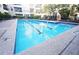 Inviting community lap pool for exercise or relaxation, surrounded by lounge chairs and lush landscaping at 1850 Cotillion Dr # 3123, Dunwoody, GA 30338