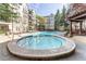 Inviting community pool and hot tub with surrounding lounge chairs and manicured landscaping, perfect for relaxing at 1850 Cotillion Dr # 3123, Dunwoody, GA 30338